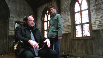 Dean has Crowley chained up inside the church.